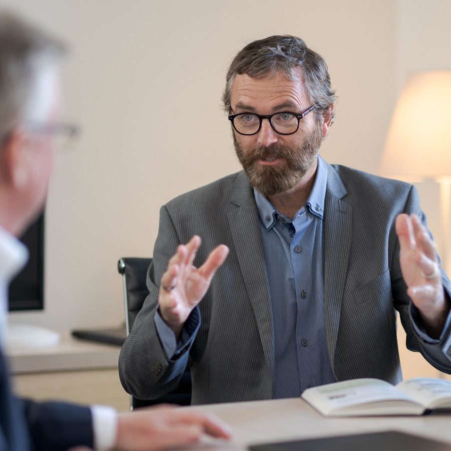 A partner presenting a case plan to colleagues